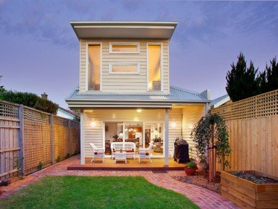 a house with a fence and lawn